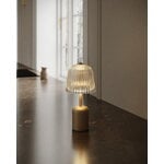 Nuura Asteea portable table lamp, satin brass - ripple clear, decoration image