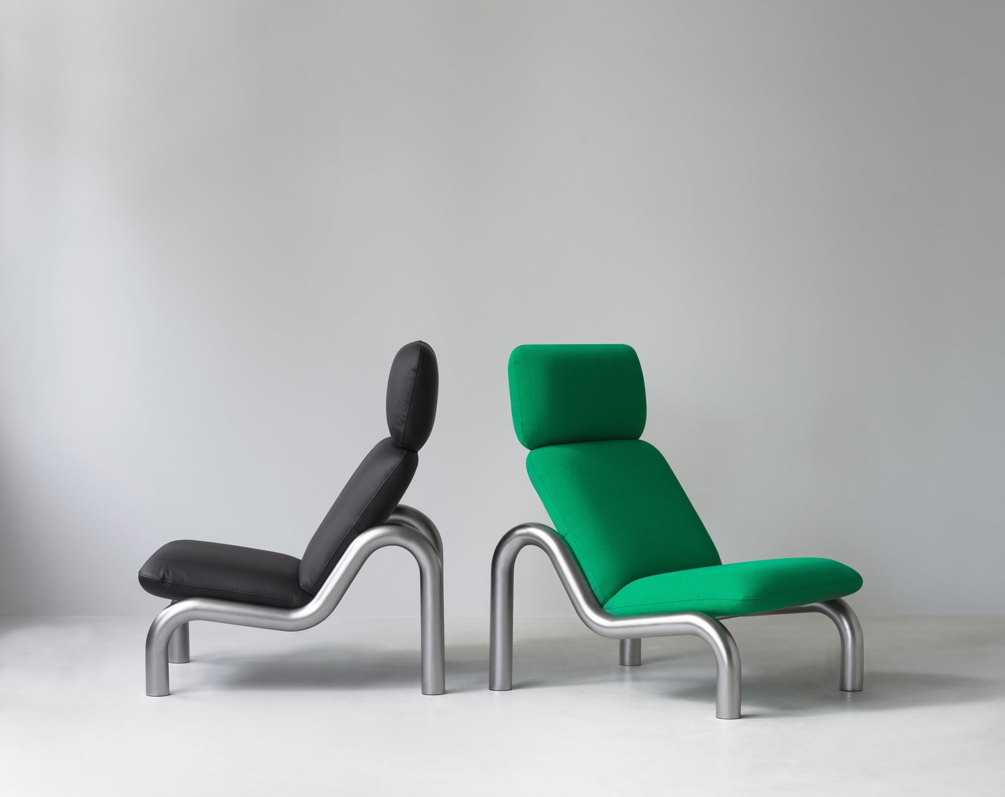 Black and green lounge chairs displayed together.
