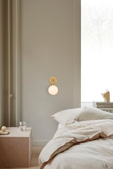 Nuura Apiales wall lamp, brushed brass - opal white, decoration image