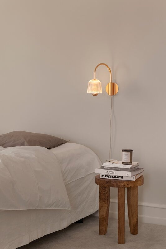 Nuura Asteea wall lamp, satin brass - ripple clear, decoration image