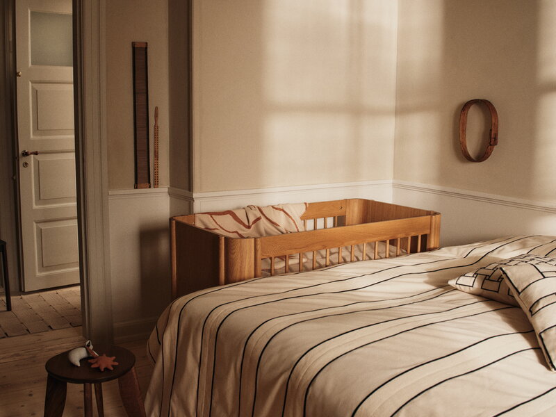 Ferm Living Tilu baby cot, natural oak, decoration image