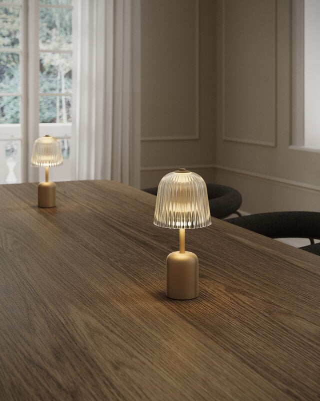 Nuura Asteea portable table lamp, satin brass - ripple clear, decoration image