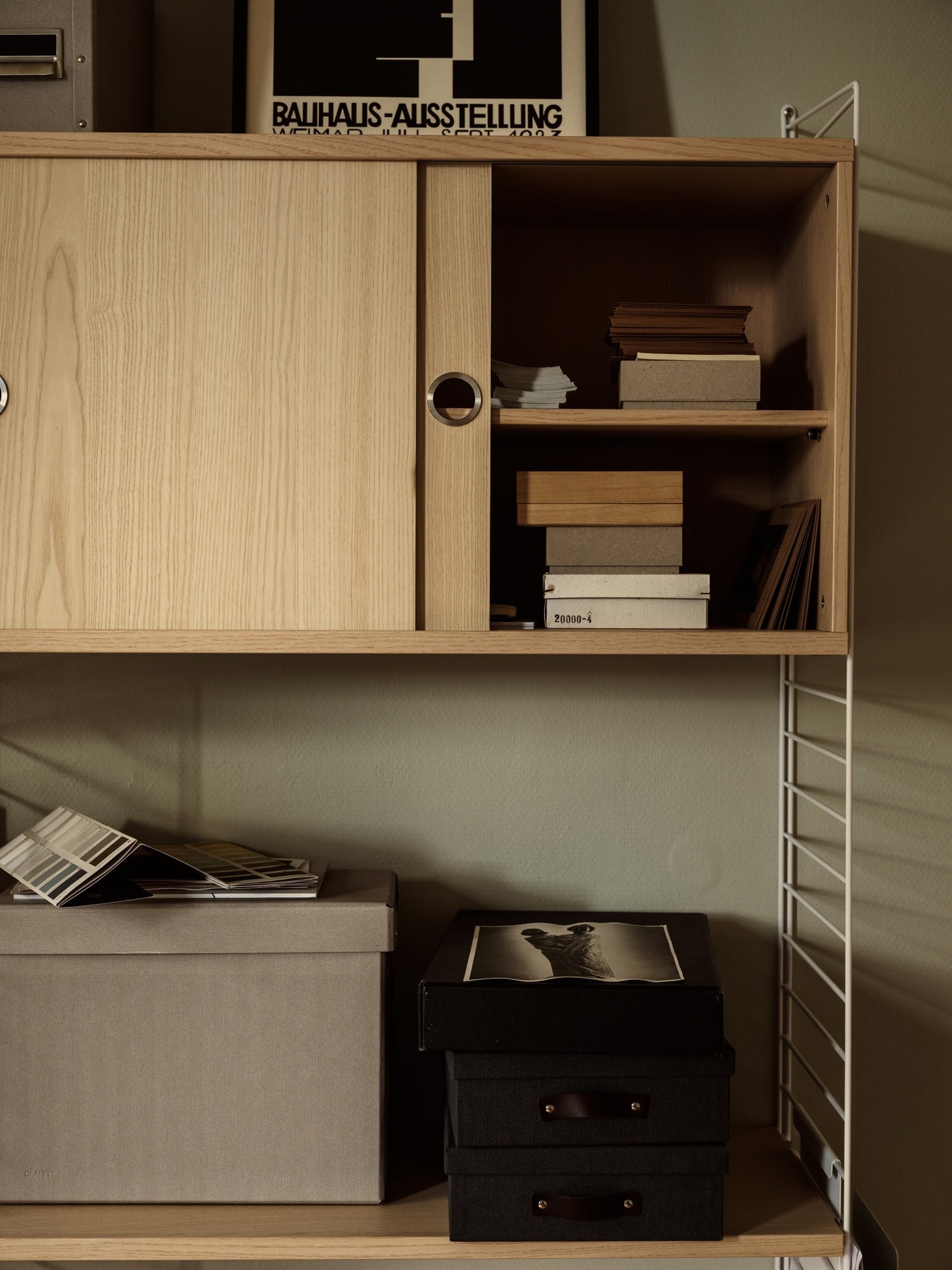Wooden cabinet with glass doors and open shelves.