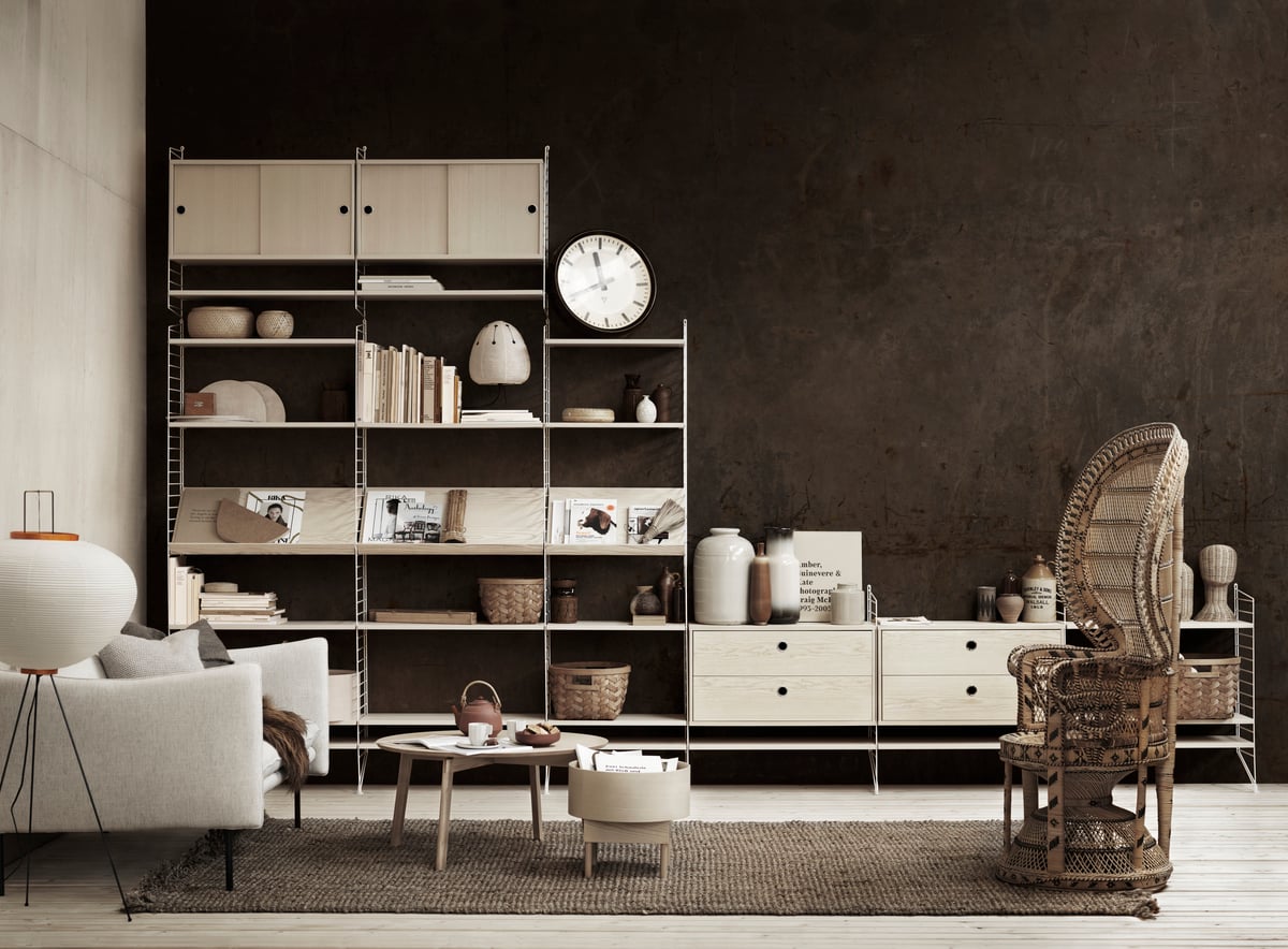 Living room with dark walls, wooden furniture, and decorative items.